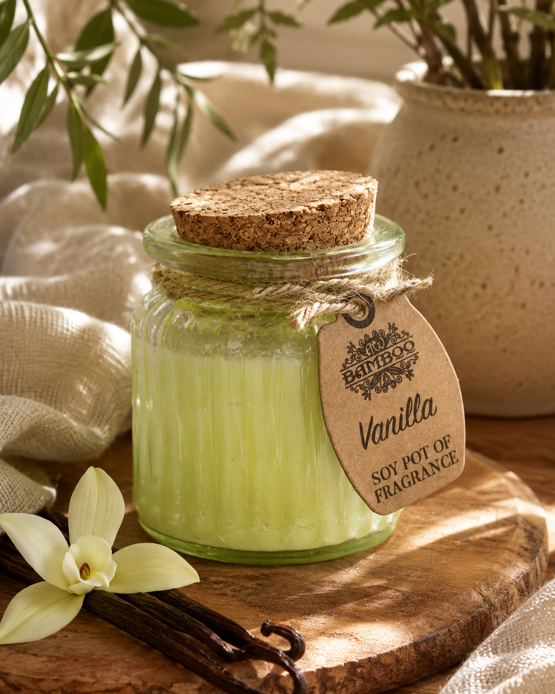 Vanilla doftljus i varm lifestylemiljö med vaniljblomma och vaniljstänger